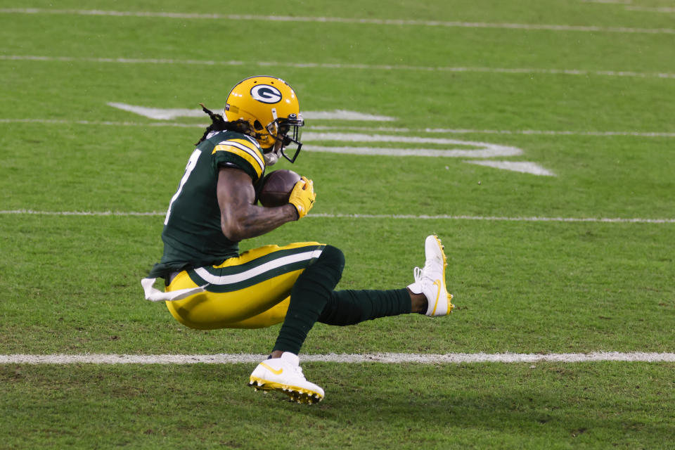 Green Bay Packers' Davante Adams catches a touchdown pass from Aaron Rodgers during the first half of an NFL divisional playoff football game against the Los Angeles Rams, Saturday, Jan. 16, 2021, in Green Bay, Wis. (AP Photo/Matt Ludtke)