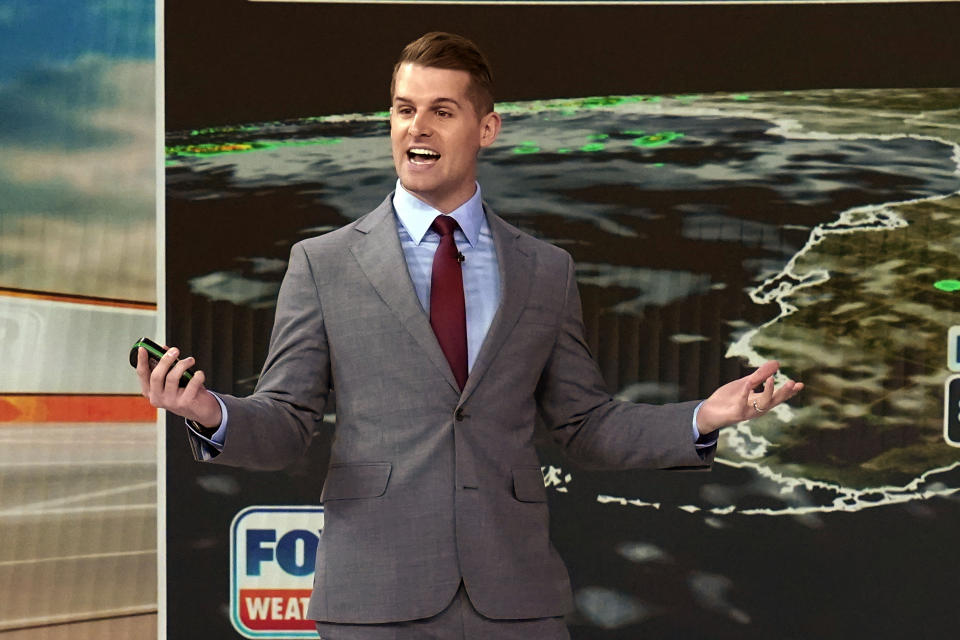 Meteorologist Stephen Morgan rehearses on the Fox Weather set at News Corporation headquarters in New York, Wednesday, Oct. 20, 2021. Fox Weather, a free streaming service and app, will launch on Monday. (AP Photo/Richard Drew)