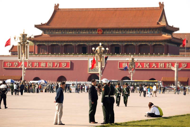 Chinese soldiers check a man's identification on Tiananmen Square in central Beijing on April 17, 2009. On May 10, 1990, China, in an attempt to show an improving human rights record, released 211 people arrested during protests in Tiananmen Square. File Photo by Stephen Shaver/UPI