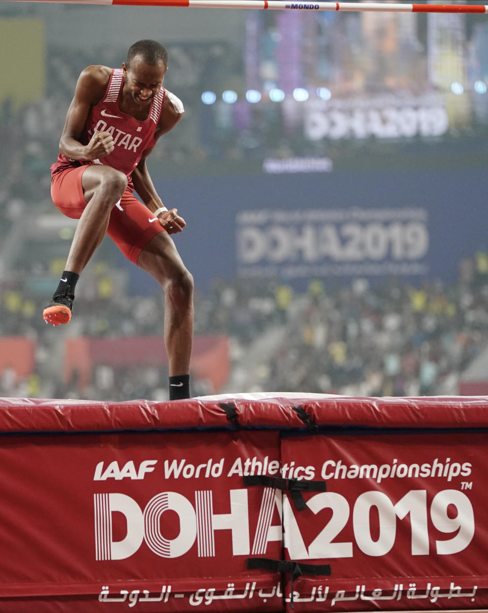 Gold medalist Mutaz Essa Barshim, of Qatar, celebrates after the men's high jump final at the World Athletics Championships in Doha, Qatar, Friday, Oct. 4, 2019. Barshim won the gold medal. (AP Photo/David J. Phillip)