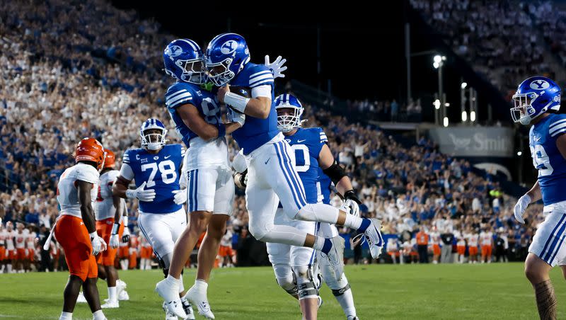 BYU Cougars wide receiver Parker Kingston (82) and quarterback Kedon Slovis (10) celebrate after Slovis scored a touchdown, putting BYU up 7-0 after the PAT, during the game against the Sam Houston Bearkats at LaVell Edwards Stadium in Provo on Saturday, Sept. 2, 2023.