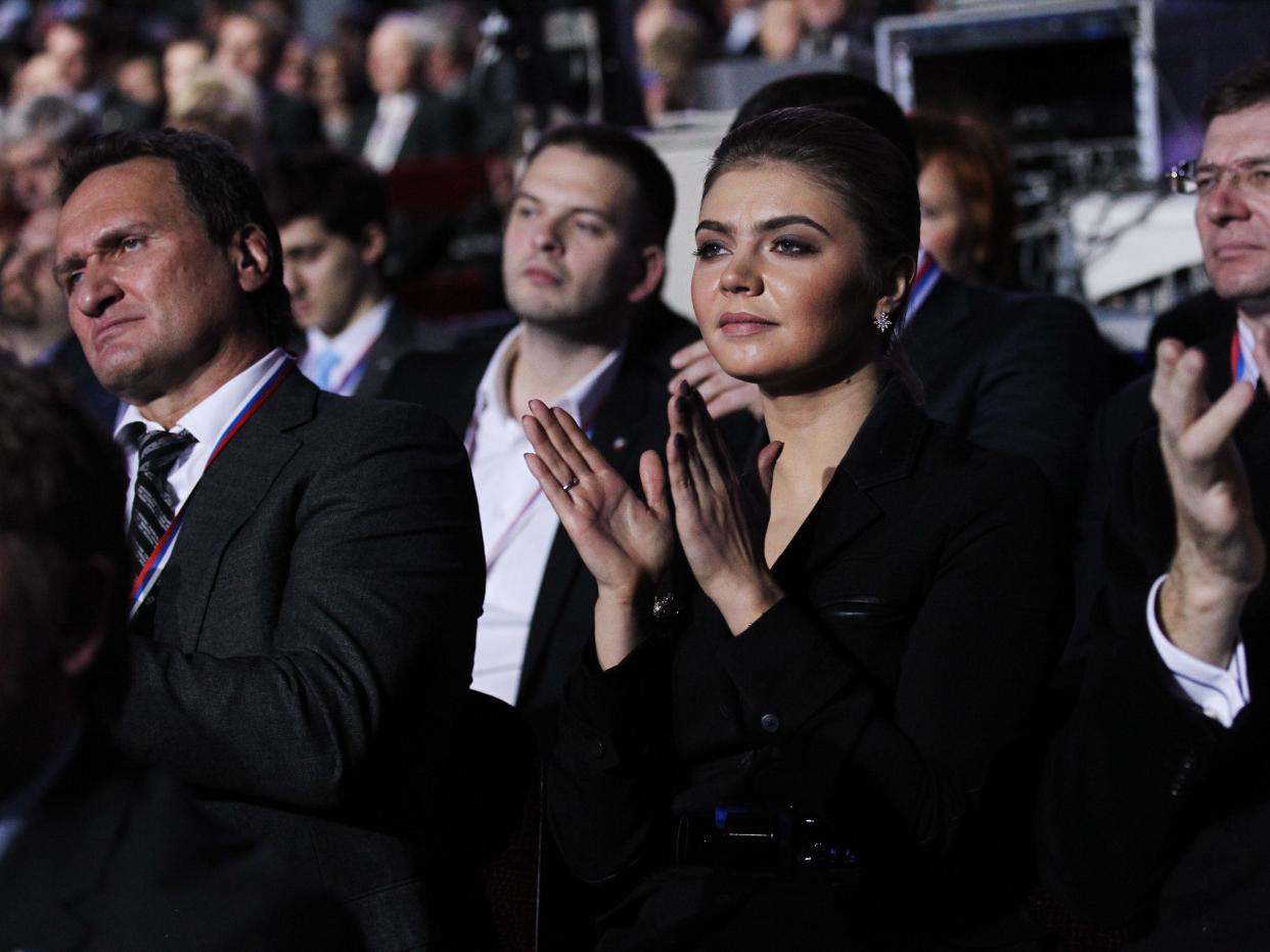 Russian politician and former Olympic Champion, Alina Kabaeva, aplauds as Prime Minister Vladimir Putin (not pictured) delivers his speech at the congress of the United Russia Party November, 27, 2011 in Moscow, Russia.