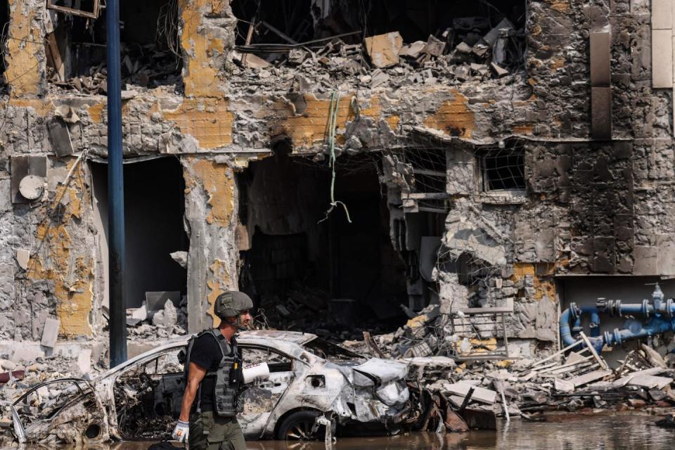 A member of the security forces walks past an Israeli police station in Sderot on Oct 8, 2023. <a href="https://www.gettyimages.com/detail/news-photo/member-of-the-security-forces-walks-past-an-israeli-police-news-photo/1712638347?adppopup=true" rel="nofollow noopener" target="_blank" data-ylk="slk:Ronaldo Schemidt/AFP via Getty Images;elm:context_link;itc:0;sec:content-canvas" class="link ">Ronaldo Schemidt/AFP via Getty Images</a>