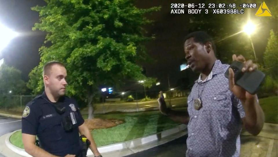 In this June 12, 2020, file photo from a screen grab taken from body camera video provided by the Atlanta Police Department Rayshard Brooks, right, speaks with Officer Garrett Rolfe, left, in the parking lot of a Wendy's restaurant, in Atlanta. Former Atlanta Police Officer, Rolfe's attorney said Thursday, April 22, 2021, that his client didn't get a chance to defend himself before he was fired for fatally shooting Brooks, a Black man who had been running away from two white officers after he resisted arrest and fired a stun gun at one of them. (Atlanta Police Department via AP, File)