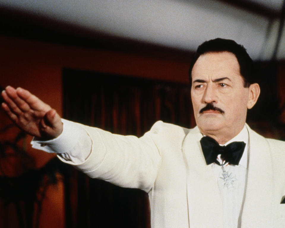 Gregory Peck (1916-2003), US actor, wearing a white jacket and white shirt, with a black bow tie, giving the Nazi salute with his right arm outstretched in a publicity still issued for the film, 'The Boys from Brazil', 1978. The thriller, directed by Franklin J Schaffner (1920-1989) , starred Peck as 'Dr Josef Mengele'. (Photo by Silver Screen Collection/Getty Images)