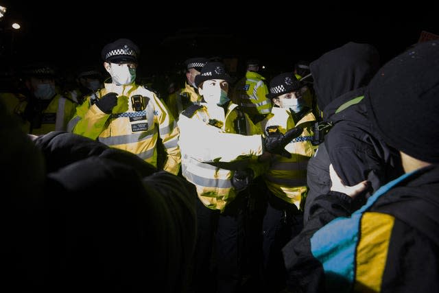 People clash with police as they gather at the Clapham Common vigil for Sarah Everard