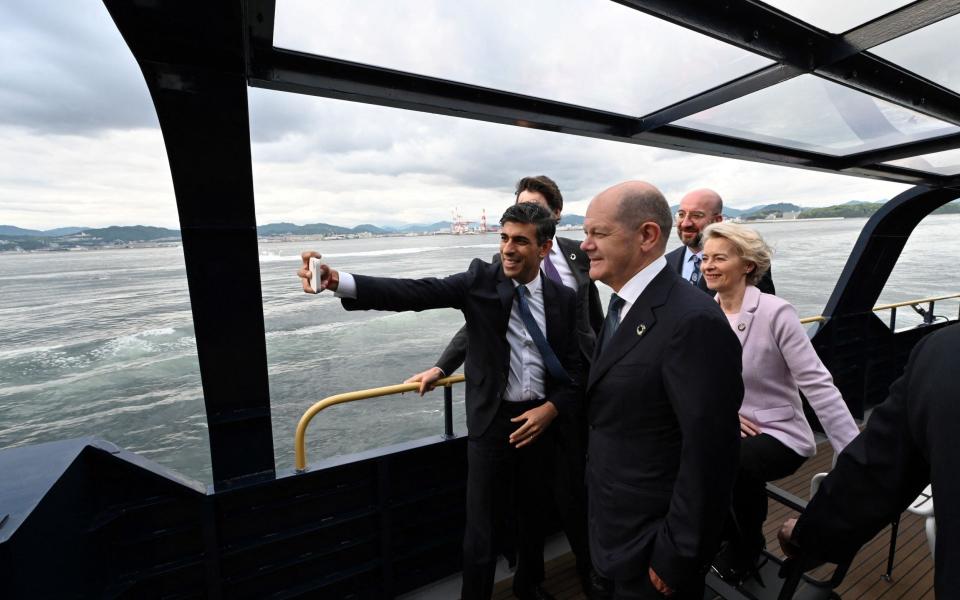 Prime Minister Rishi Sunak (L) is pictured taking a group selfie with other leaders as they travel by boat from Hiroshima to the nearby island of Miyajima during the G7 summit - AFP 