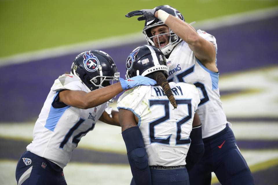 Tennessee Titans running back Derrick Henry (22) celebrates his game-winning touchdown with wide receiver Kalif Raymond, left, and tight end Anthony Firkser during overtime of an NFL football game against the Baltimore Ravens, Sunday, Nov. 22, 2020, in Baltimore. The Titans won 30-24 in overtime. (AP Photo/Nick Wass)