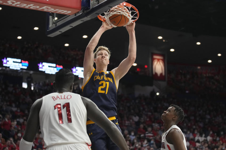 California forward Lars Thiemann (21) dunks over Arizona center Oumar Ballo (11) and guard Adama Bal during the first half of an NCAA college basketball game, Saturday, March 5, 2022, in Tucson, Ariz. (AP Photo/Rick Scuteri)