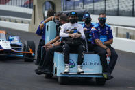 J.R. Hildebrand, left foreground, rides out to the pit area with his team during practice for the Indianapolis 500 auto race at Indianapolis Motor Speedway in Indianapolis, Friday, Aug. 14, 2020. (AP Photo/Michael Conroy)