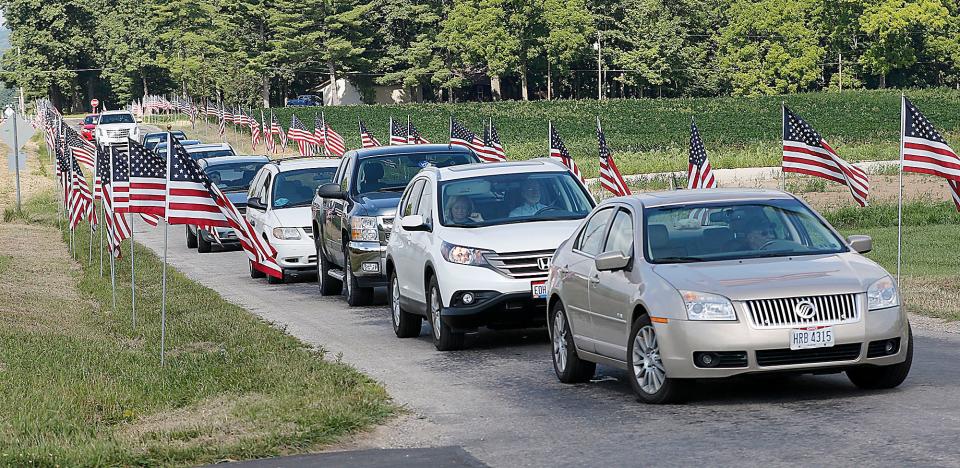 Guests arrive for the the ninth annual Ashland County Veterans Appreciation Day at the Ashland County Airport with the road entering the airport lined with American flags on Saturday, Aug. 6, 2022. TOM E. PUSKAR/ASHLAND TIMES-GAZETTE