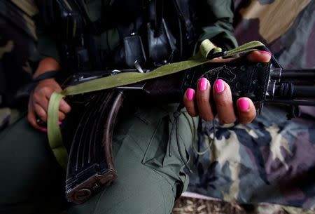 Leidi, a member of the 51st Front of the Revolutionary Armed Forces of Colombia (FARC), poses for a picture at a camp in Cordillera Oriental, Colombia, August 16, 2016. REUTERS/John Vizcaino