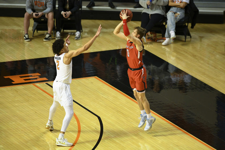 Oklahoma State guard Cade Cunningham, left, defends against a shot by Texas Tech guard Mac McClung, right, during an NCAA college basketball game Monday, Feb. 22, 2021, in Stillwater, Okla. (AP Photo/Brody Schmidt)