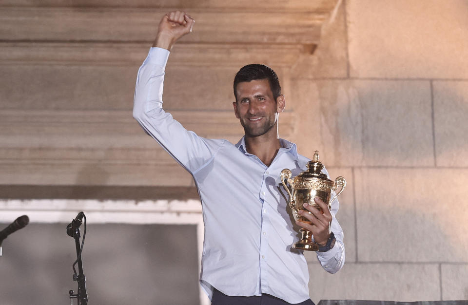 Novak Djokovic (pictured) waves to fans with the Wimbledon trophy.