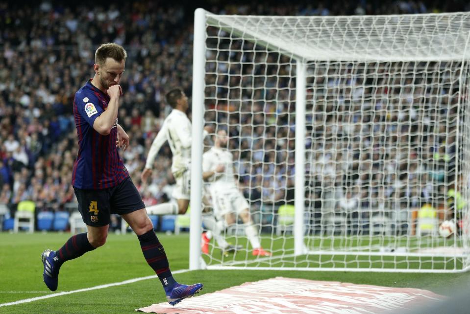 Barcelona midfielder Ivan Rakitic, left, after scoring the opening goal during the Spanish La Liga soccer match between Real Madrid and FC Barcelona at the Bernabeu stadium in Madrid, Saturday, March 2, 2019. (AP Photo/Manu Fernandez)