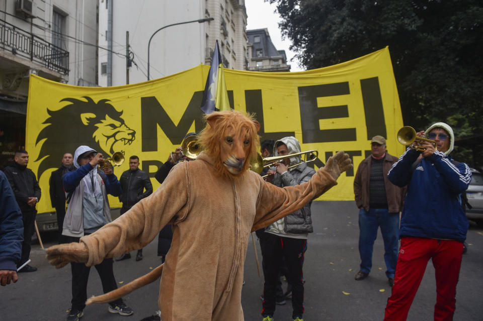 Supporters of Argentine President Javier Milei arrive to a stadium for the presentation of his book titled "Capitalism, Socialism and the Neoclassical Trap" in Buenos Aires, Argentina, Wednesday, May 22, 2024. (AP Photo/Gustavo Garello)