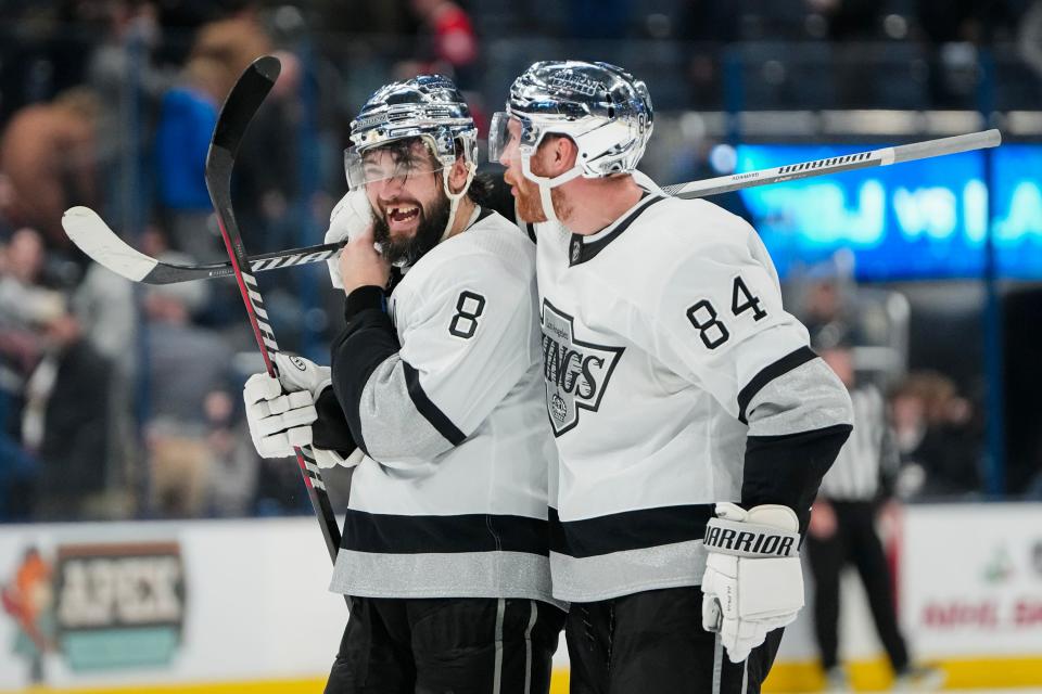 Dec 5, 2023; Columbus, Ohio, USA; Los Angeles Kings defenseman Vladislav Gavrikov (84) celebrates a goal by Los Angeles Kings defenseman Drew Doughty (8) in overtime of the NHL game at Nationwide Arena. The Blue Jackets lost 4-3 in overtime.