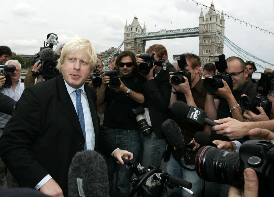 FILE - Britain Conservative Party MP, Boris Johnson, left, speaks to the media to launch his campaign as a candidate to be the Mayor of London, outside City Hall in central London, Monday, July 16, 2007. He was the mayor who reveled in the glory of hosting the 2012 London Olympics, and the man who led the Conservatives to a whopping election victory on the back of his mission to “get Brexit done.” But Boris Johnson’s time as prime minister was marred by his handling of the coronavirus pandemic and a steady stream of ethics allegations. (AP Photo/Sang Tan, File)