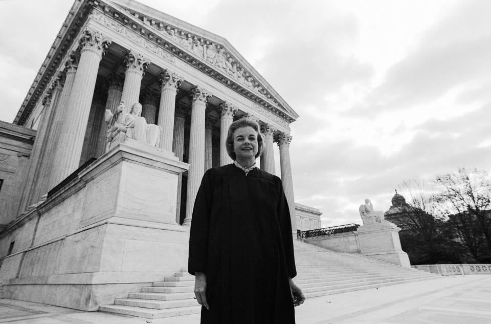 Sandra Day O'Connor stands in front of the US Supreme Court Building