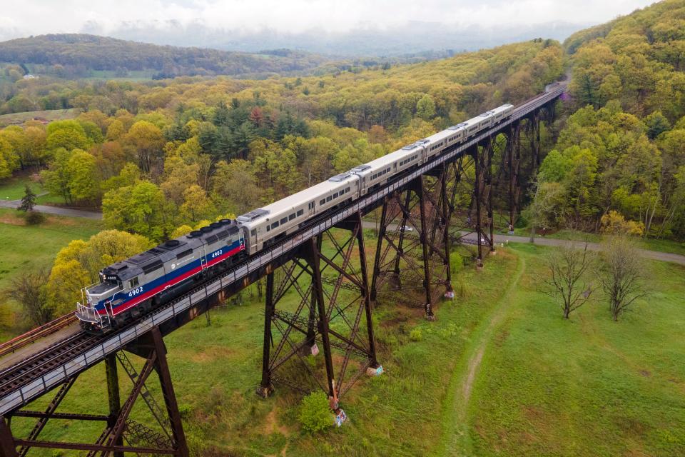A Metro-North Railroad passenger train travels on the Moodna Viaduct steel railroad trestle in Cornwall, New York, on Thursday, April 27, 2023.