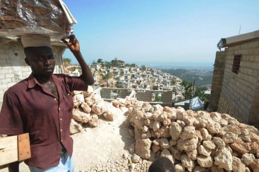 A man walks in a hillside slum in Port-au-Prince, Haiti, on July 12. About 80 percent of people in the capital live below the poverty line, many in squalid tent cities or in rickety housing near the edge of deadly ravines