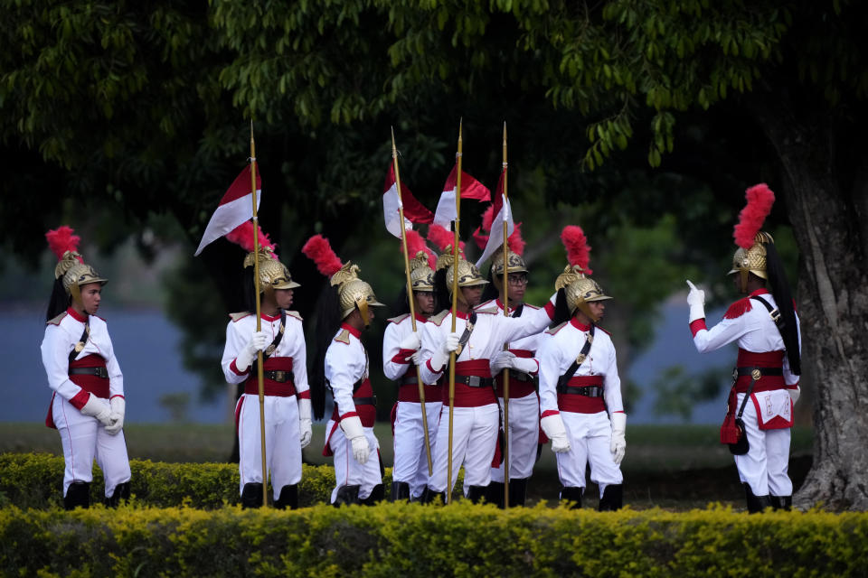 Soldiers from the presidential guard prepare to attend the ceremony to unveil the Brazilian flag in front of the official residence of the Alvorada Palace, where Brazil's President Luiz Inacio Lula da Silva is recovering from surgery after being discharged from hospital, in Brasilia, Brazil, Sunday, Oct. 1, 2023. (AP Photo/Eraldo Peres)