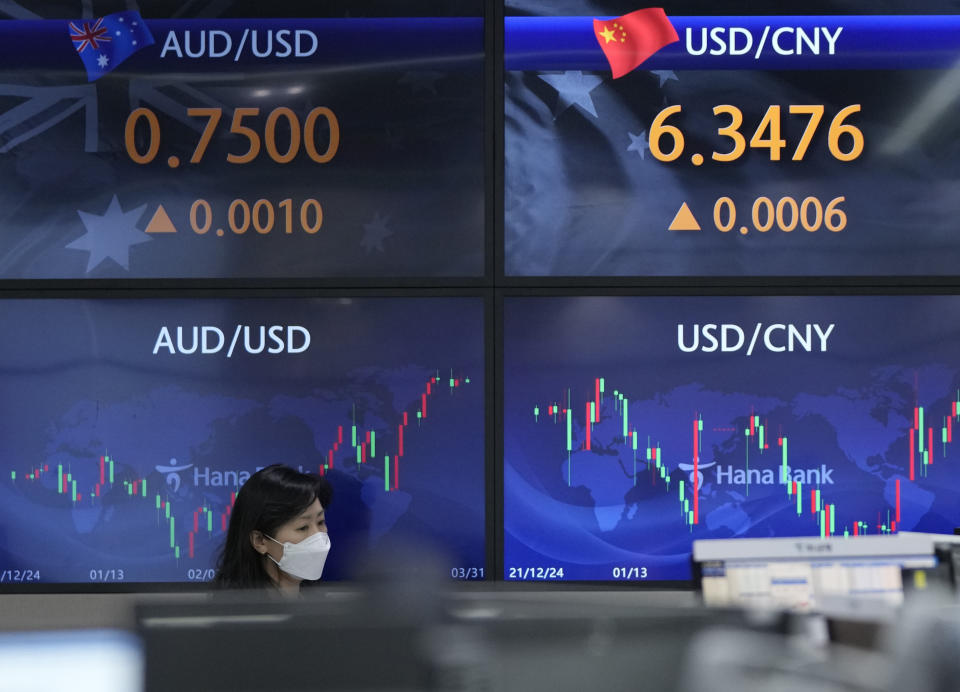 A currency trader watches monitors at the foreign exchange dealing room of the KEB Hana Bank headquarters in Seoul, South Korea, Thursday, March 31, 2022. Asian stock markets sank Thursday after Chinese manufacturing weakened and Russian shelling around Ukraine's capital shook hopes of progress in peace talks. (AP Photo/Ahn Young-joon)