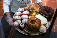 <p>A woman fills a tray of pastries at a sweets store. Mexico have very high levels of child obesity and an increasing rates of type 2 diabetes among children. The government of Mexico has been faced with the enormous fiscal and health consequences of obesity and made major regulatory changes. These include taxing two components of the diet, sugar-sweetened beverages (SSBs) and non-essential foods (unhealthy food with excessive saturated fat, sugar and/or sodium). (Photograph by Silvia Landi) </p>