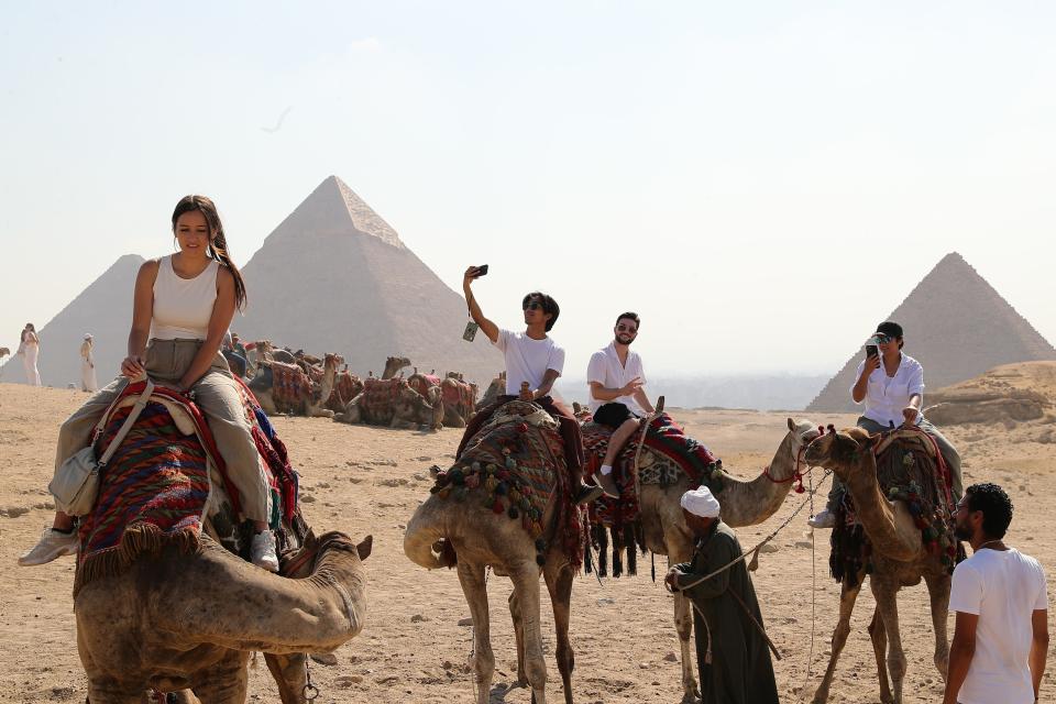 Tourists visit the Giza Pyramids scenic spot in Giza, Egypt, on July 14, 2024. Tourism revenue of Egypt hit 6.6 billion U.S. dollars in the first half of 2024, surpassing the 6.3 billion dollars during the same period in 2023. (Photo by Wang Dongzhen/Xinhua via Getty Images)