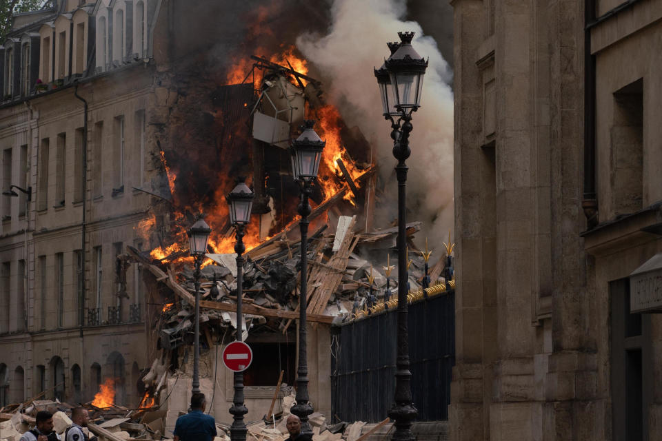 Smoke billows from rubble of a building in Paris after an apparent gas explosion on June 21, 2023.  / Credit: ABDULMONAM EASSA/AFP via Getty Images