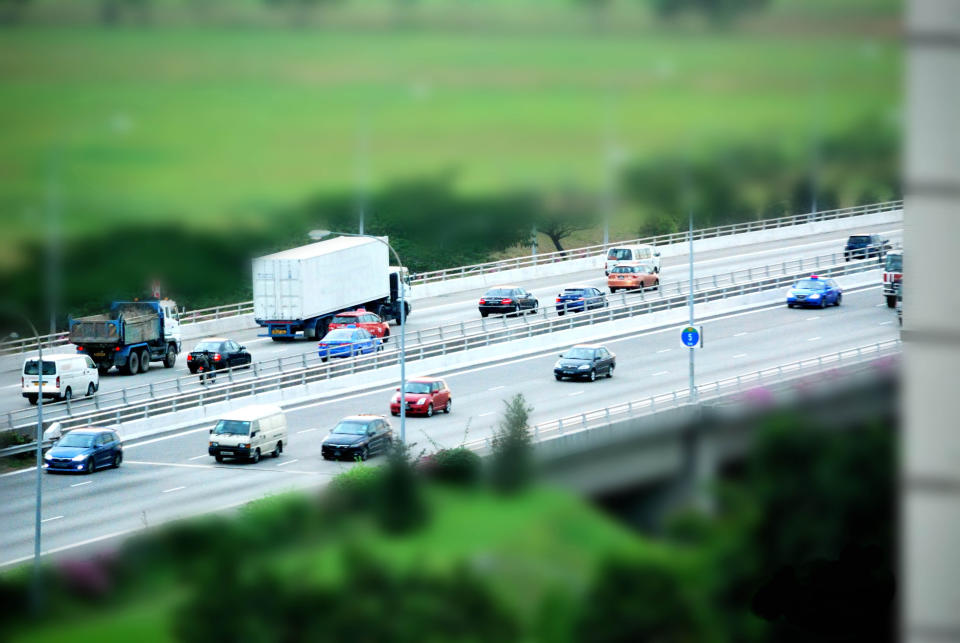 Vehicles zooming by on the Tampines Expressway in Singapore, illustrating a story on the latest COE prices.