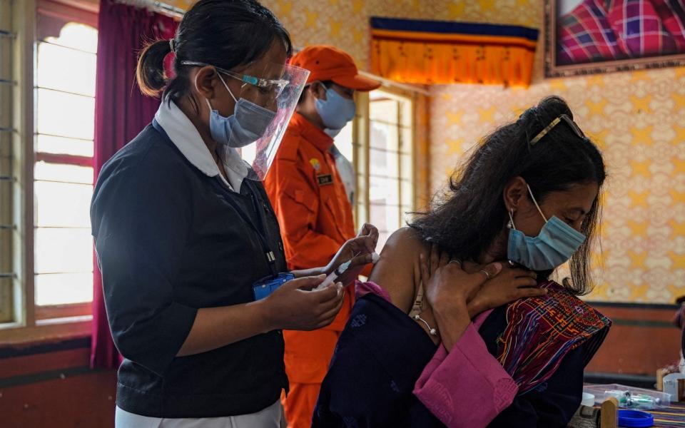 A coronavirus vaccine is given to a health worker in Bhutan - Upasana Dahal/AFP