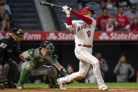 Los Angeles Angels' Shohei Ohtani strikes out with Oakland Athletics catcher Sean Murphy, center, and home plate umpire Larry Vanover watching during the third inning of a baseball game in Anaheim, Calif., Friday, May 20, 2022. (AP Photo/Alex Gallardo)