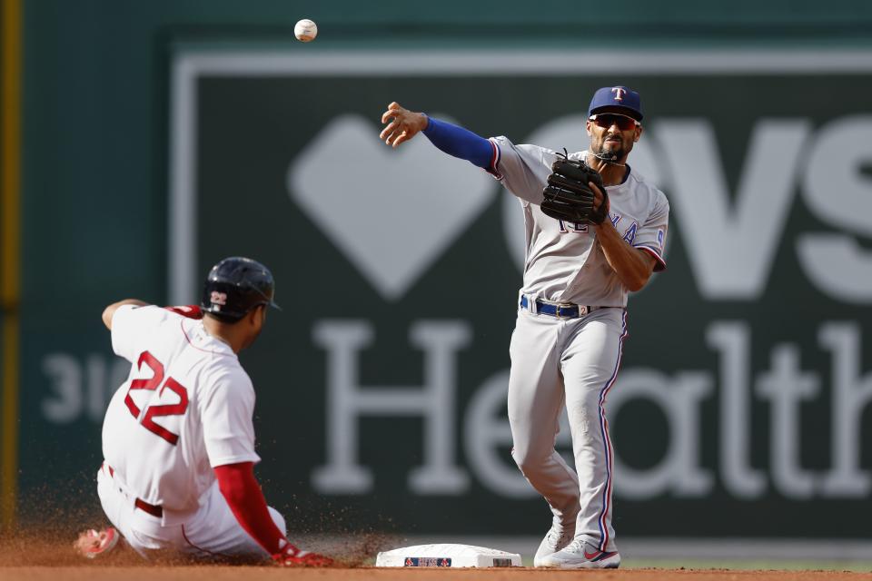Boston Red Sox's Tommy Pham (22) is forced out at second base as Texas Rangers' Marcus Semien throws to first base on a single by Xander Bogaerts during the first inning of a baseball game, Saturday, Sept. 3, 2022, in Boston. (AP Photo/Michael Dwyer)