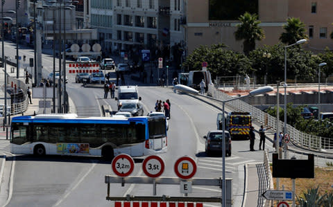 French police secure the area in the French port city of Marseille after one person was killed and another injured after a car crashed into two bus shelters - Credit: PHILIPPE LAURENSON/Reuters