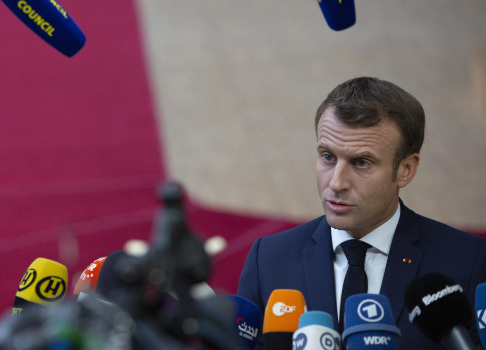 French President Emmanuel Macron speaks with the media as he arrives for an EU summit at the Europa building in Brussels, Thursday, Oct. 17, 2019. Britain and the European Union reached a new tentative Brexit deal on Thursday, hoping to finally escape the acrimony, divisions and frustration of their three-year divorce battle. (AP Photo/Virginia Mayo)