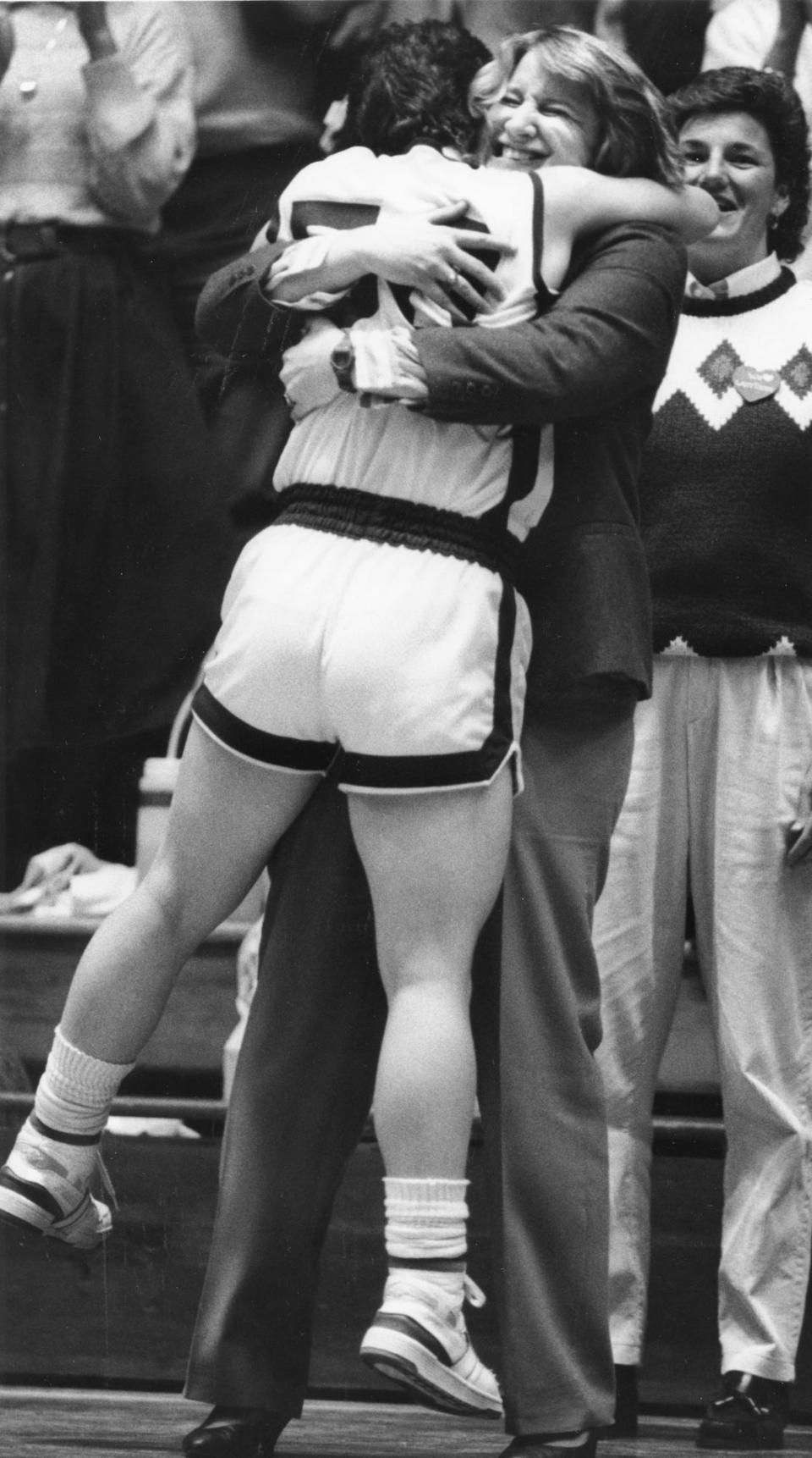 In this Feb. 21, 1988 file photo, Jan Conner, former Benton Central girls basketball coach, embraces Tina Humm.