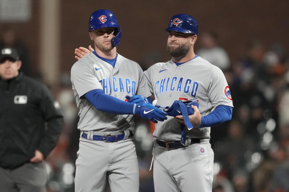 Chicago Cubs' Nico Hoerner, left, is congratulated by first base coach Mike Napoli after hitting a two-run single against the San Francisco Giants during the seventh inning of a baseball game in San Francisco, Friday, June 9, 2023. (AP Photo/Jeff Chiu)