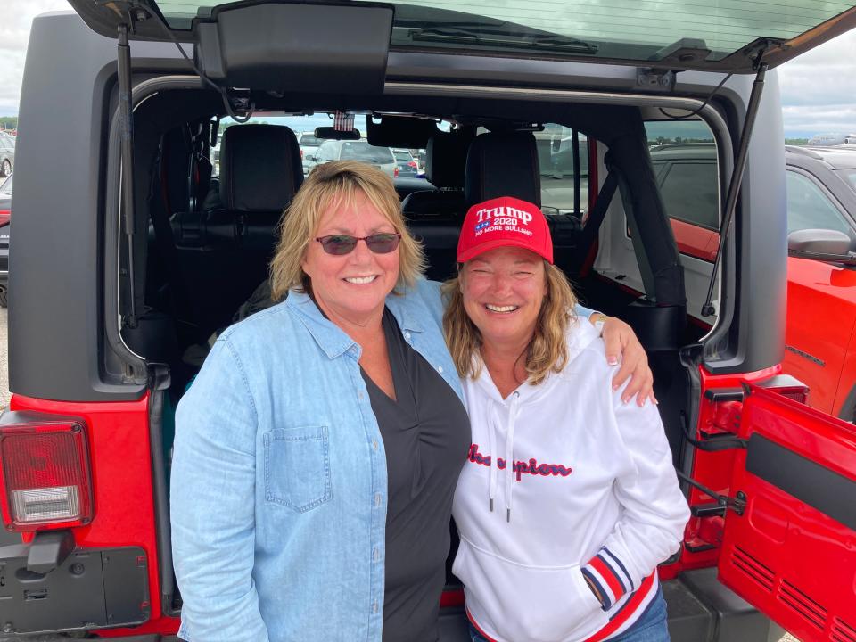 Tina Oldford, left, and Jennifer Hay traveled from Howell to see President Donald Trump's rally at MBS International Airport in Freeland, Michigan on Thursday, Setp. 10, 2020. Both said they had never voted before, but planned to cast their ballots for Trump this fall.