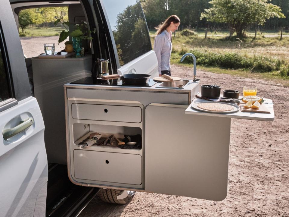 A kitchen extended out the side of the van.