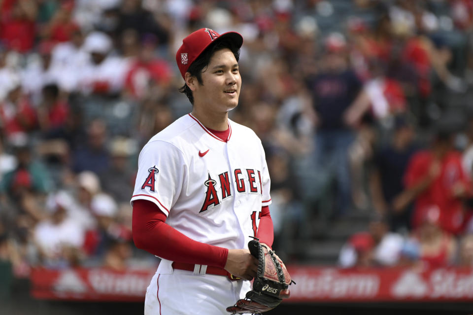 Los Angeles Angels pitcher Shohei Ohtani smiles after finishing the seventh inning of a baseball game against the Seattle Mariners, Sunday, Sept. 26, 2021, in Anaheim, Calif. The Mariners won 5-1. (AP Photo/Michael Owen Baker)