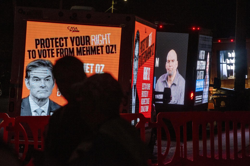 Lighted billboard trucks are parked outside before the first and only debate between U.S. Senate candidates Republican Mehmet Oz and Democrat John Fetterman, at the WHTM-TV/ABC 27 Studio in Harrisburg, Pa., Tuesday, Oct. 25, 2022. (Tom Gralish/The Philadelphia Inquirer via AP)