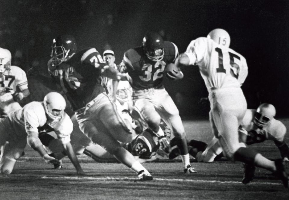 USC freshman running back O.J. Simpson, center, follows his blockers during the Trojans' 17-13 win over No. 4 Texas on Sept. 23, 1967 at the Los Angeles Coliseum. Simpson finished the game with 158 yards and a touchdown.