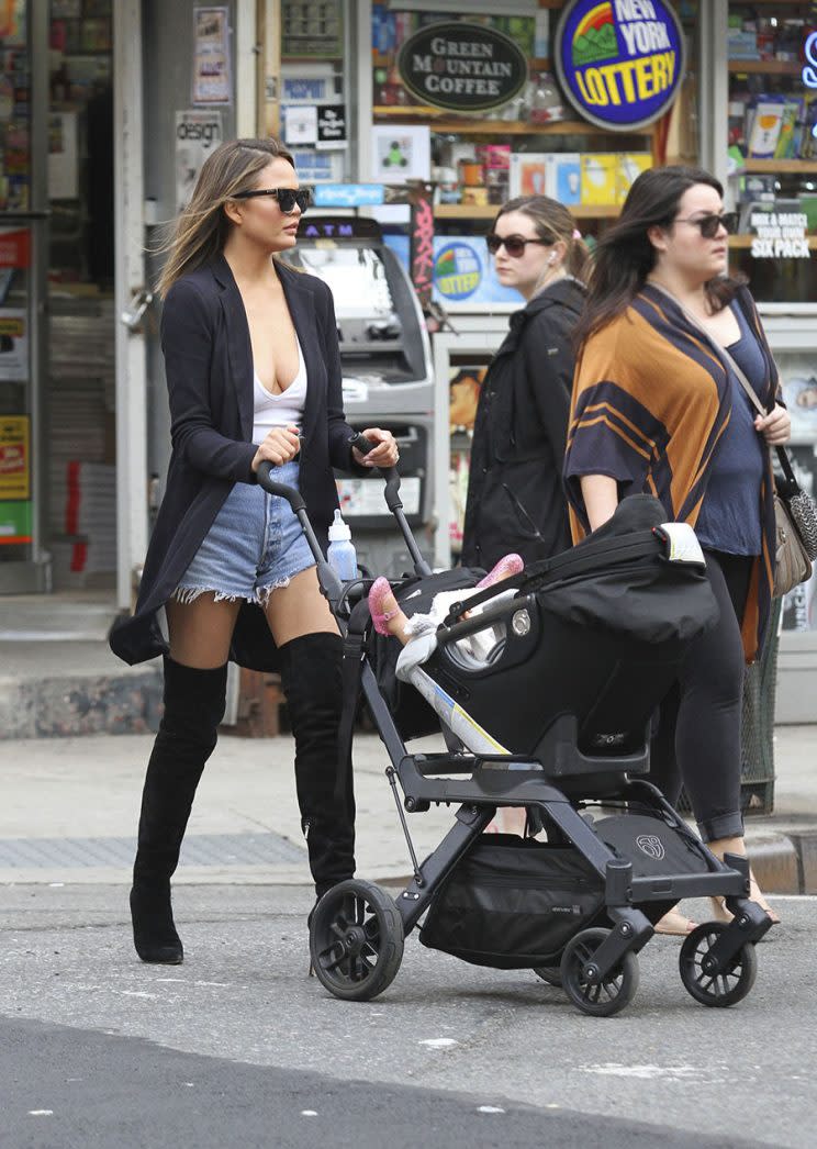 Chrissy Tiger take their daughter Luna for a walk in the Soho neighborhood of Manhattan