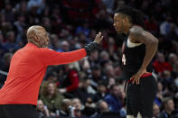 Portland Trail Blazers coach Chauncey Billups talks to forward Jabari Walker during the first half of the team's NBA basketball game against the Los Angeles Clippers in Portland, Ore., Wednesday, March 20, 2024. (AP Photo/Craig Mitchelldyer)