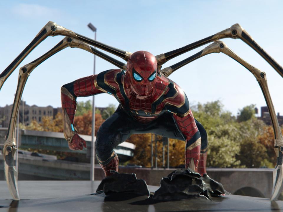 Tom Holland wearing the Spider-Man suit with iron legs in "Spider-Man: No Way Home."