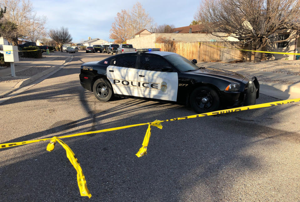 Police have a residential street cordoned off as detectives investigate the deaths of four people found Christmas Day inside a home in Rio Rancho, N.M., on Thursday, Dec. 26, 2019. All of the victims appeared to have suffered gunshot wounds, police said in a statement posted on Facebook. Police did not identify the victims or say whether a suspect or suspects have been identified. (AP Photo/Susan Montoya Bryan)