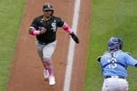 Chicago White Sox's Yermin Mercedes runs home past Kansas City Royals catcher Salvador Perez to score on a sacrifice fly hit by Leury Garcia during the second inning of a baseball game Sunday, May 9, 2021, in Kansas City, Mo. (AP Photo/Charlie Riedel)