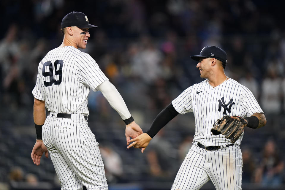 New York Yankees' Aaron Judge, left, celebrates with Gleyber Torres after the team's 14-2 win in a baseball game against the Pittsburgh Pirates on Wednesday, Sept. 21, 2022, in New York. (AP Photo/Frank Franklin II)