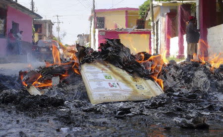 Burning electoral materials are seen outside a polling station vandalised by members of the teacher's union CNTE in Juchitan, state of Oaxaca June 7, 2015. REUTERS/Stringer